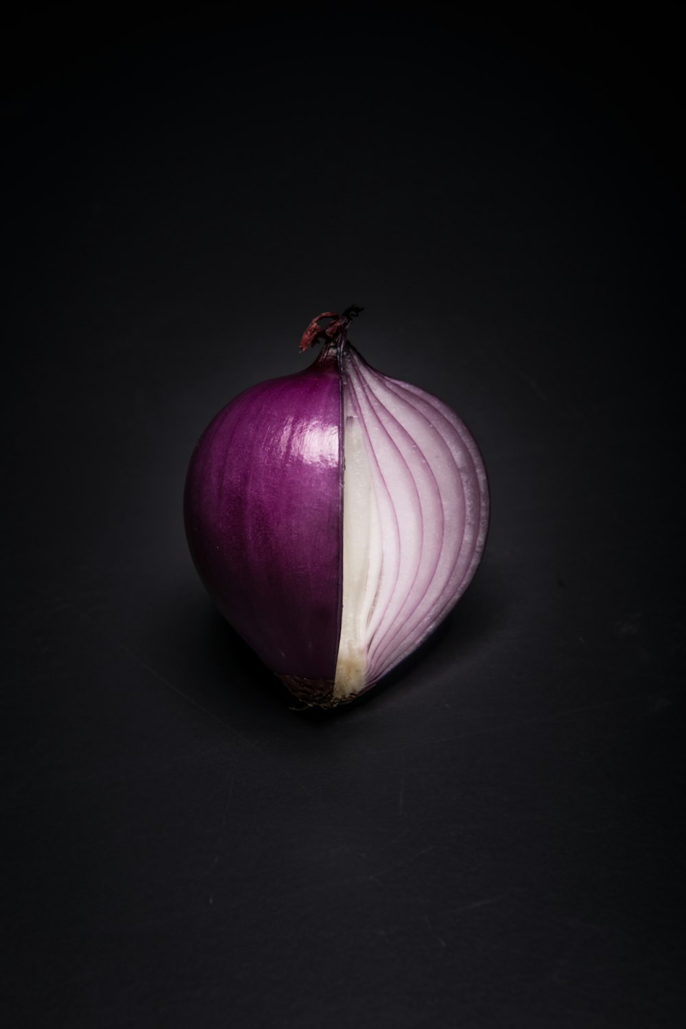 a purple onion with a white stripe on it