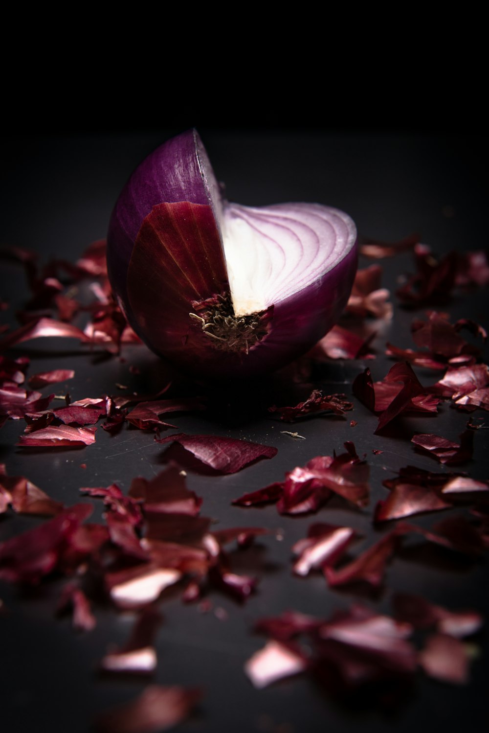 an onion and a slice of red onion on a table