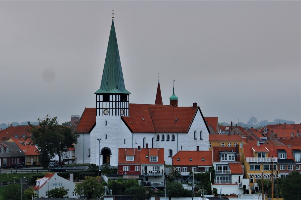 a large white building with a green steeple on top of it