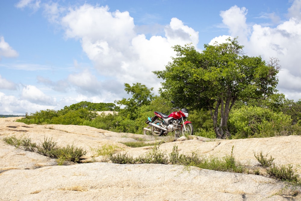 a motorcycle parked on top of a large rock