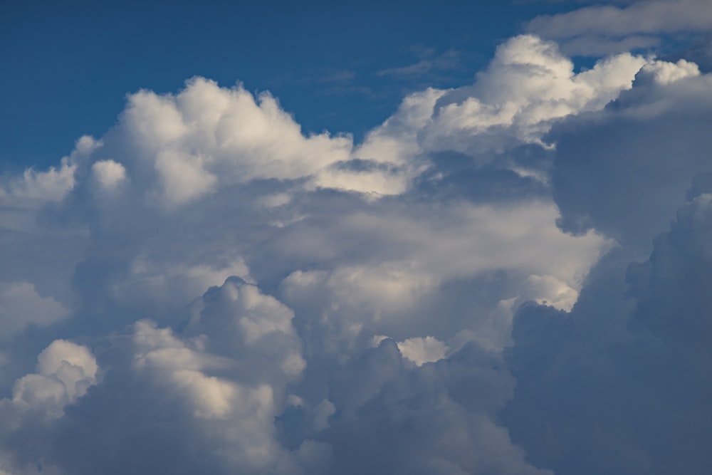 a plane flying in the sky with a lot of clouds