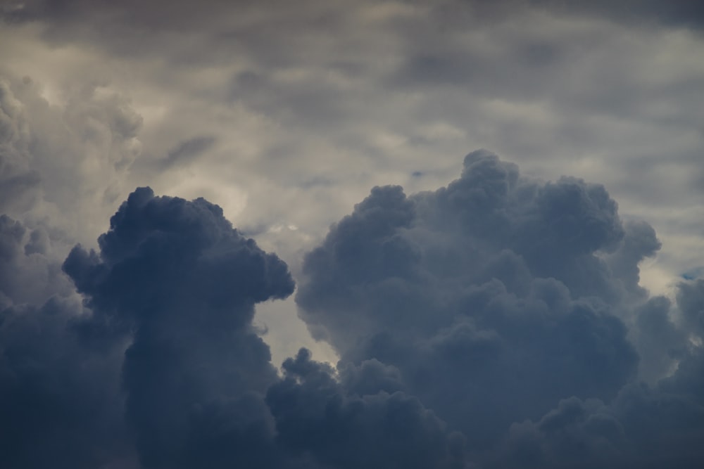 a plane flying in the sky with a lot of clouds