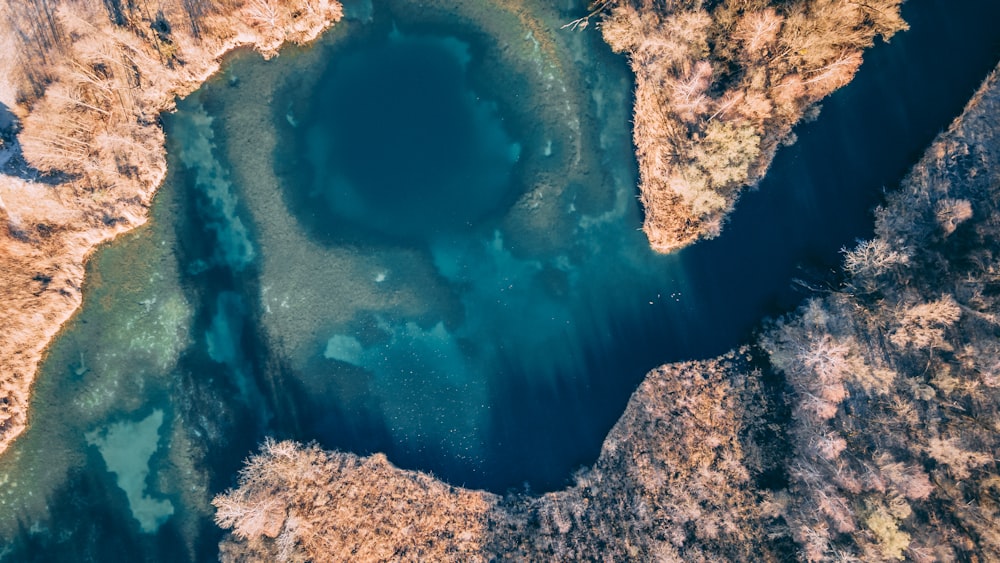 an aerial view of a lake surrounded by mountains