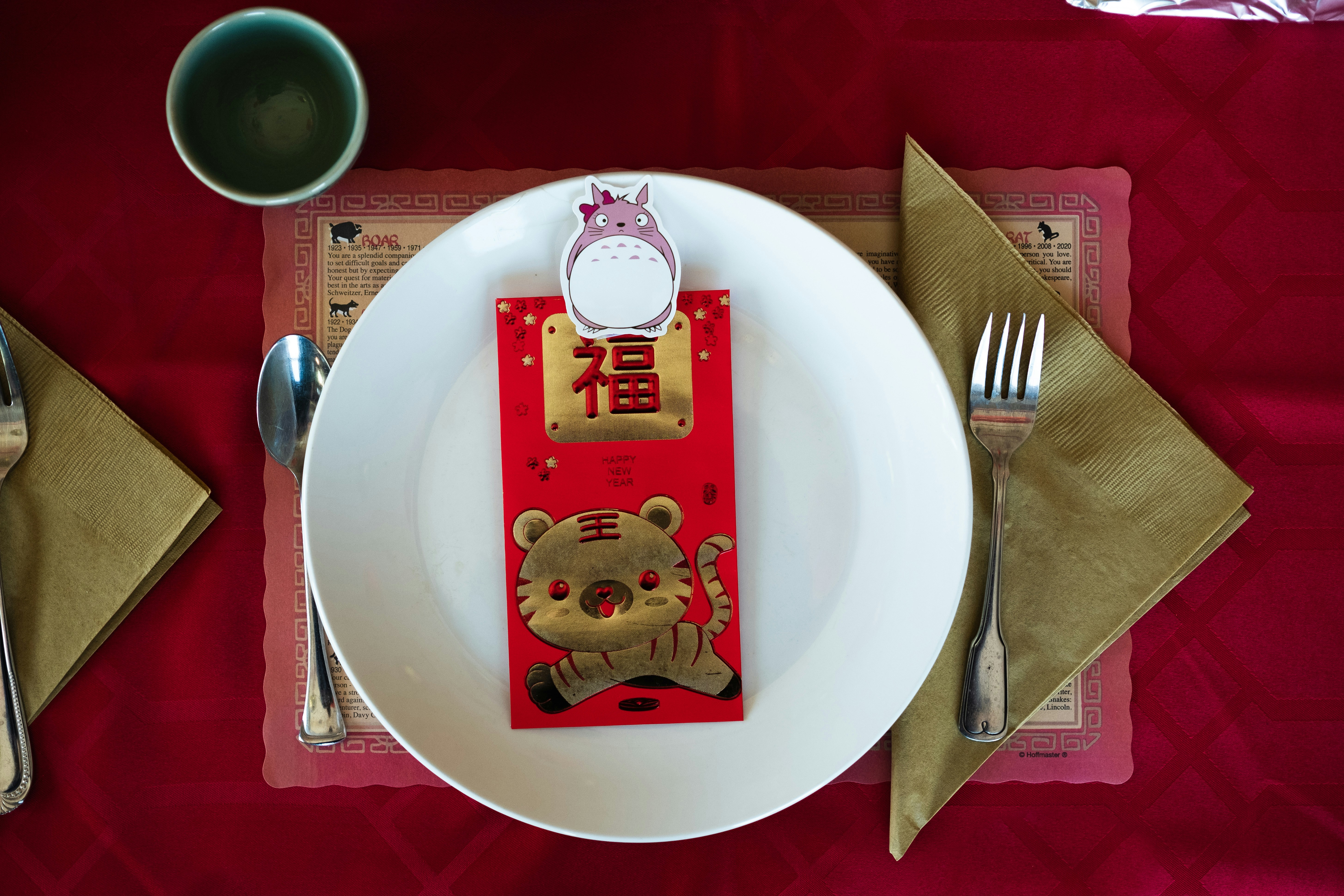 a white plate topped with a red and gold menu