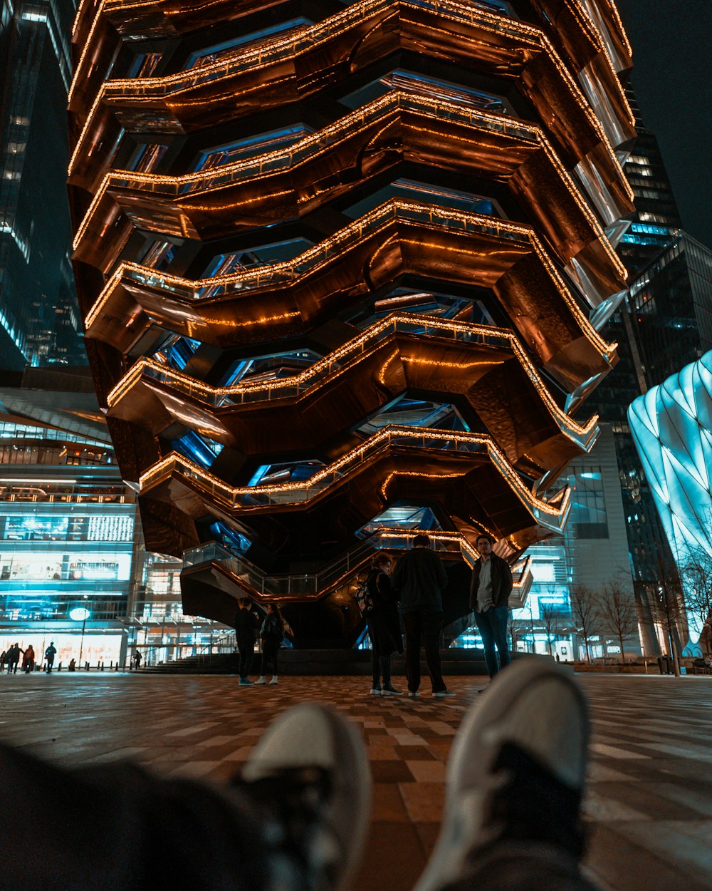 a person standing in front of a tall building