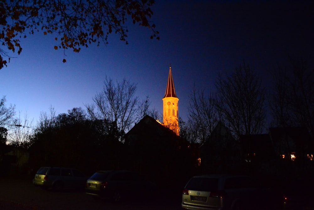 a church steeple lit up at night