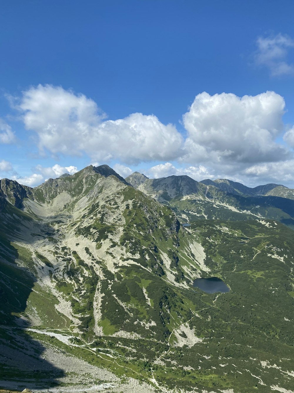 a view of a mountain range with a lake in the middle