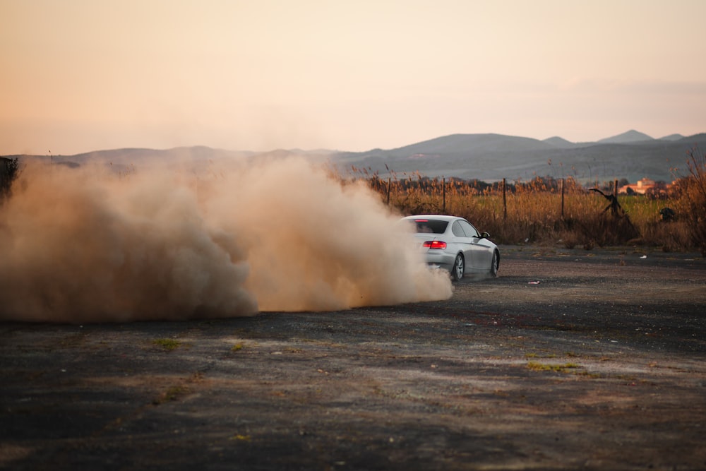 a car with a lot of dust coming out of it