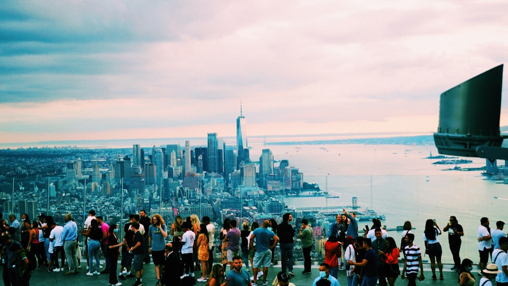 a group of people standing on top of a tall building