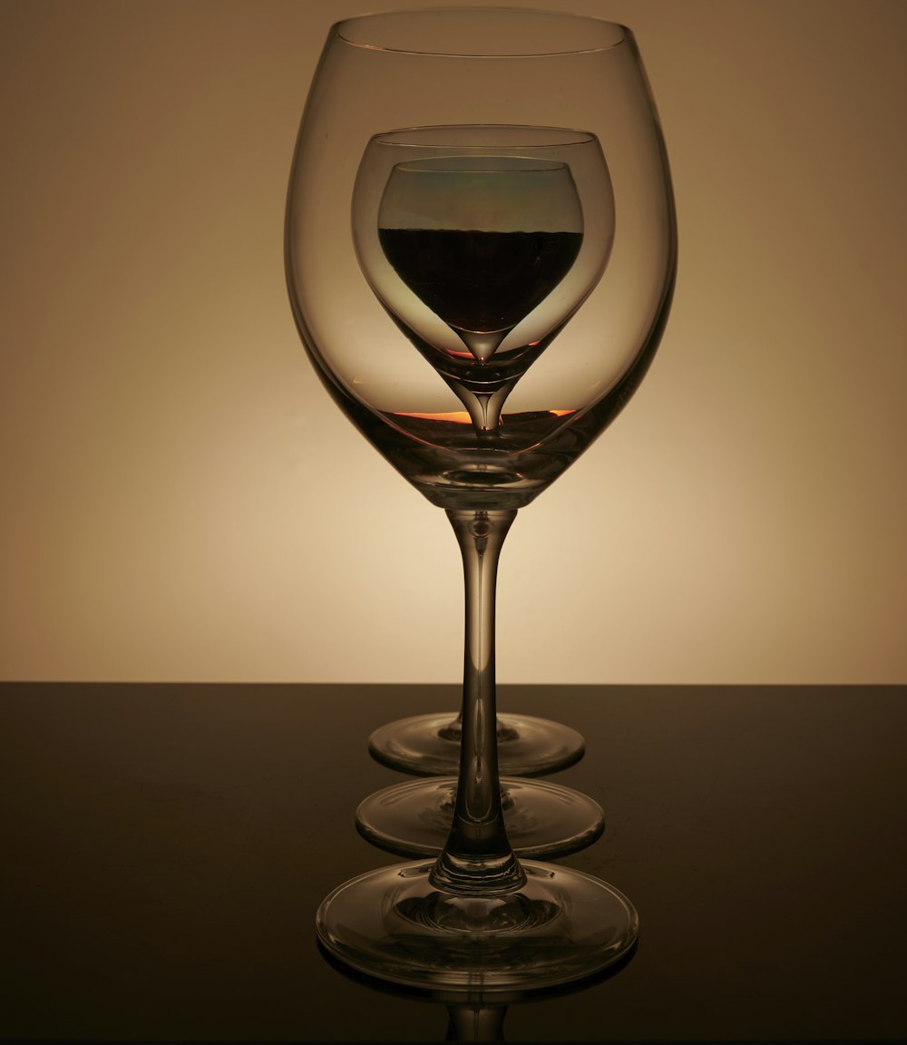 a wine glass sitting on top of a table