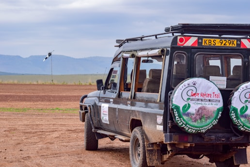 a vehicle parked on a dirt road in the middle of nowhere