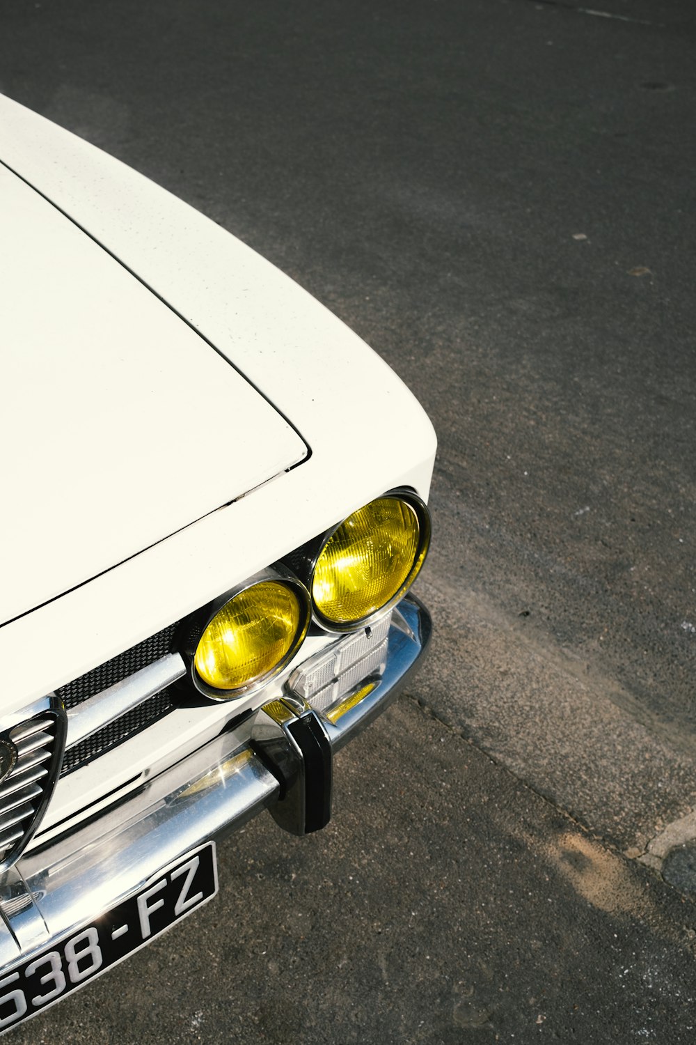 a white car parked on the side of the road