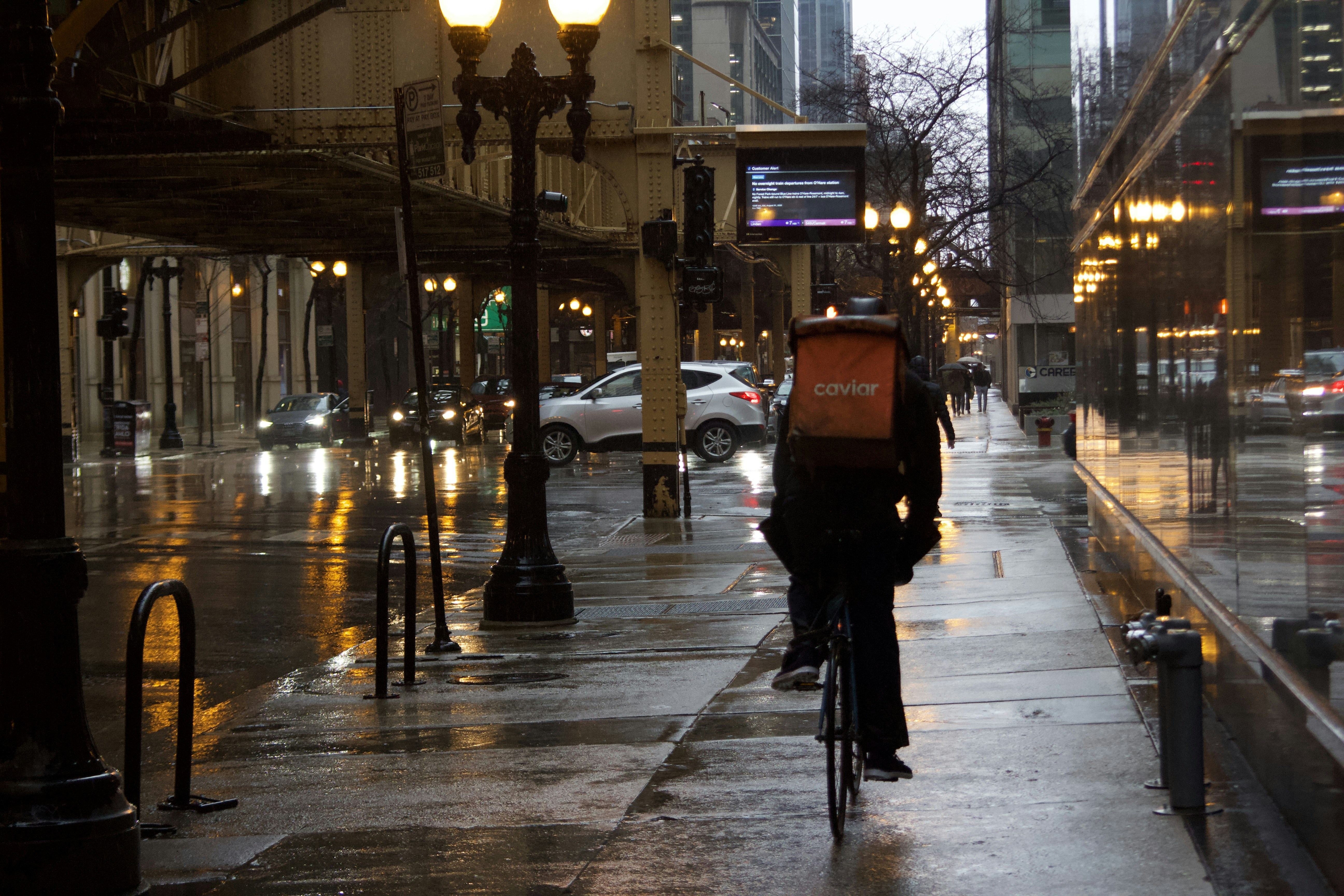 A bike messenger in Downtown Chicago during a rain storm.
