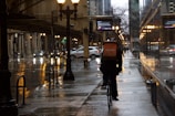 Evening cityscape with delivery riders on the move under street lights