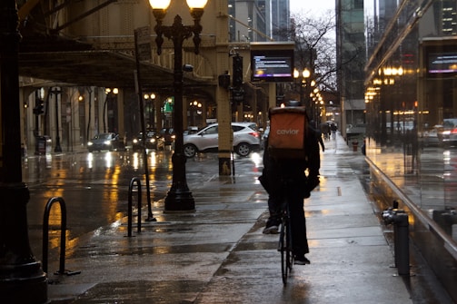 A bustling delivery rider navigating Stockholm's city streets on a bike.