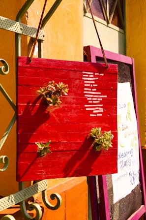 A close-up of a beautifully hand-painted wooden sign with vibrant colors.