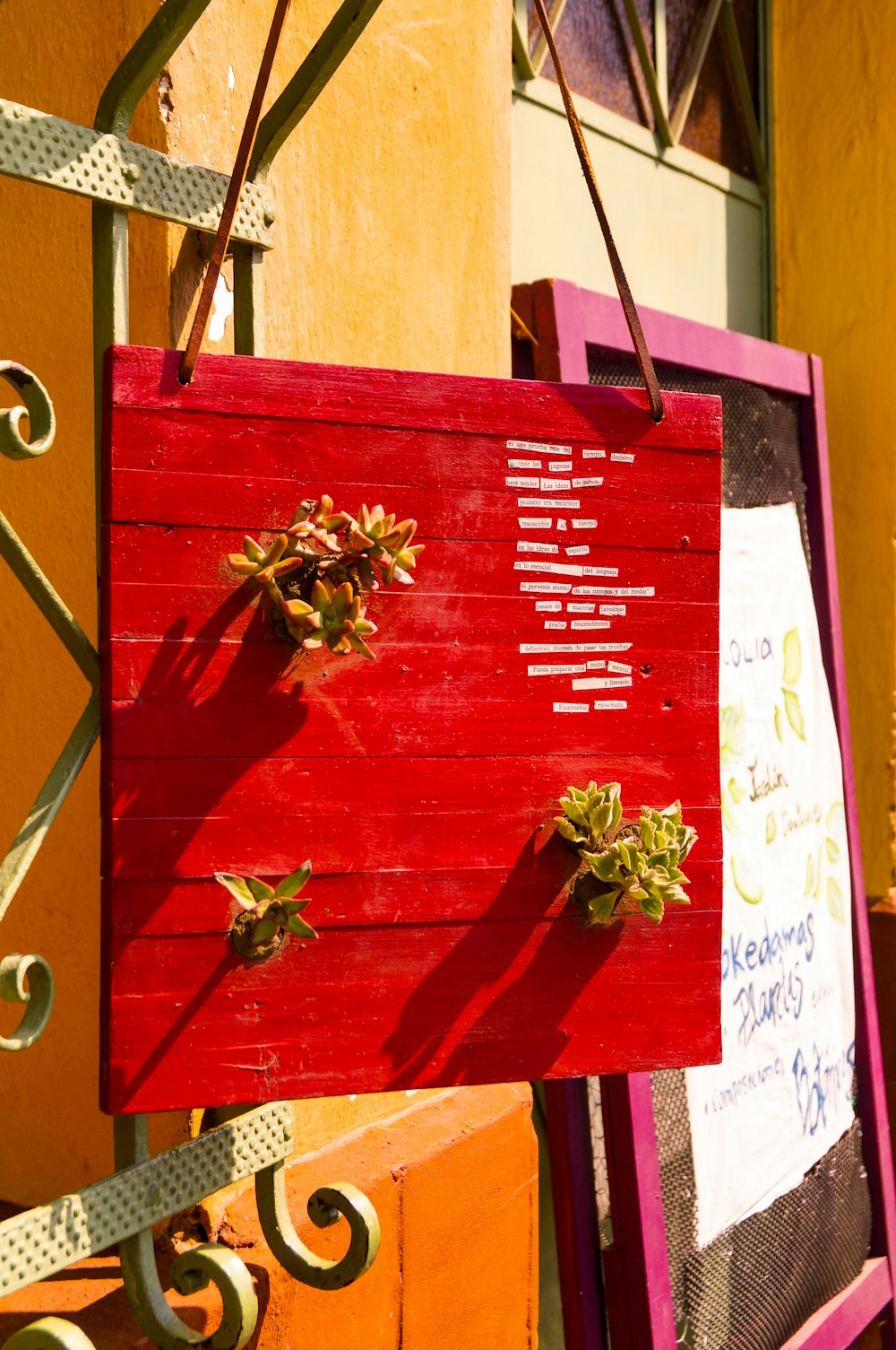 a wooden sign hanging from the side of a building