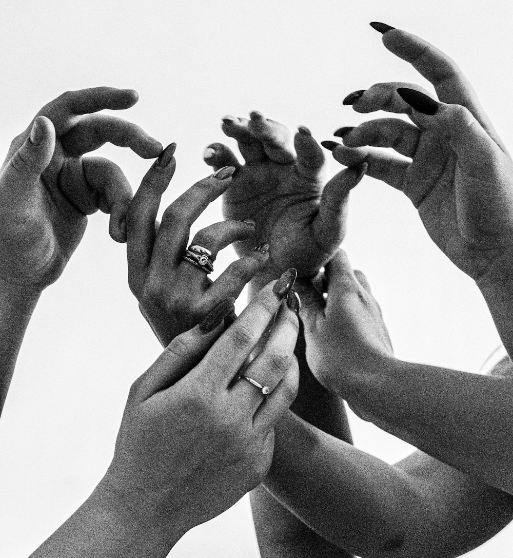 a group of people holding their hands together