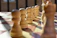 Close-up of a handcrafted marble chess set with soft natural light highlighting its smooth texture.