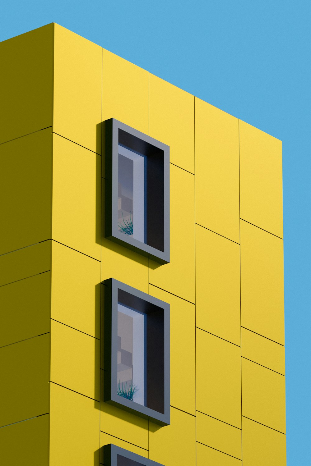 a yellow building with two windows and a blue sky in the background