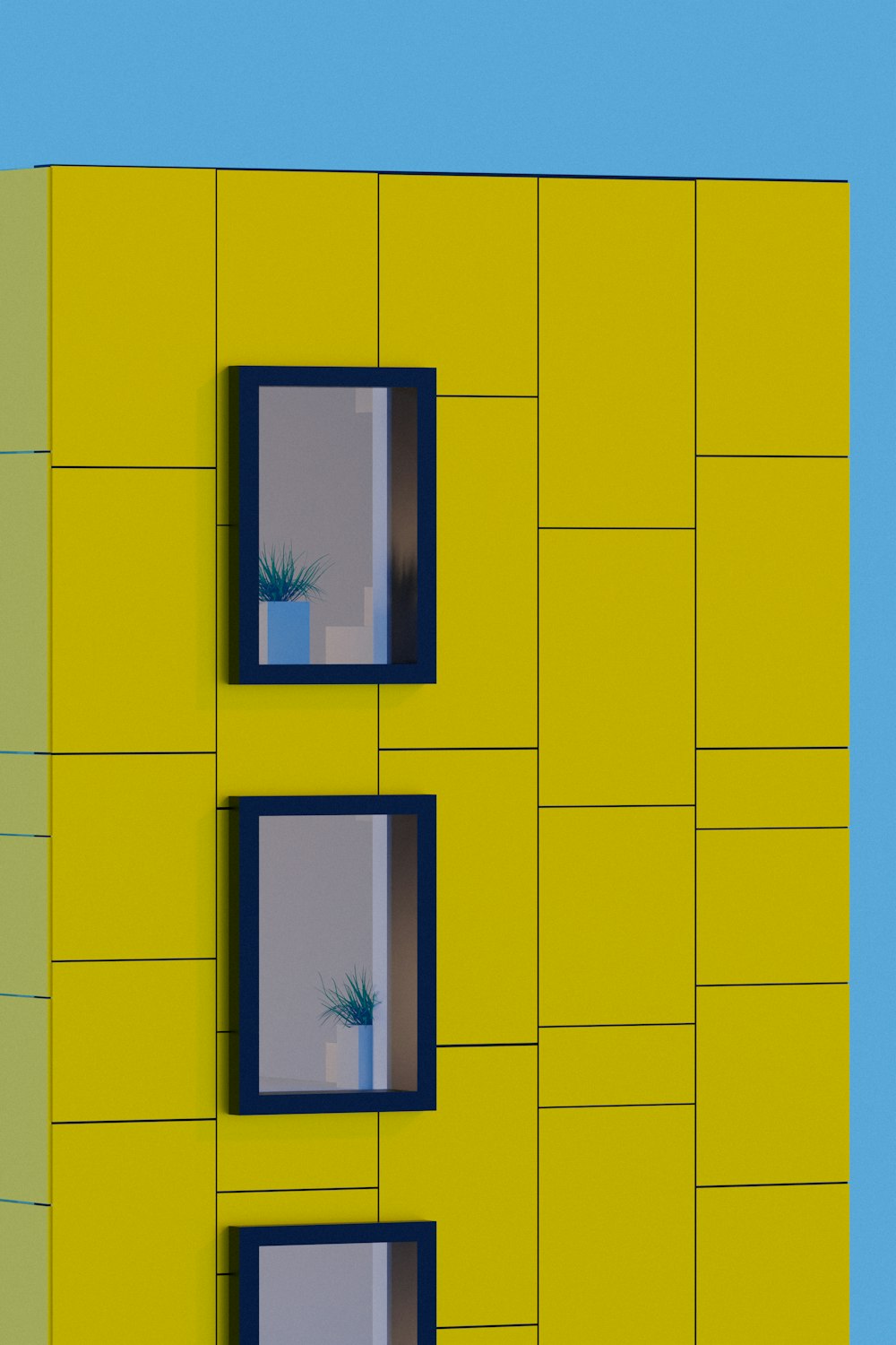 a yellow building with three windows and a plant in the window