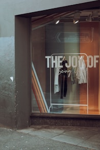 a store front window with clothes in the window