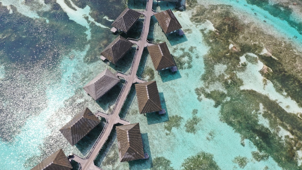 an aerial view of some huts in the water