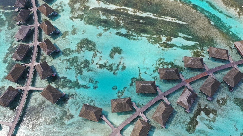 an aerial view of a bunch of huts in the water