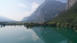 A serene lake reflecting the majestic mountains nearby.