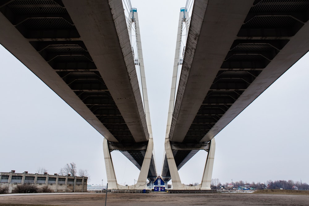 a view of the underside of a bridge from the ground