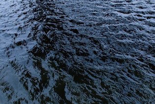 a large body of water with a boat in the distance