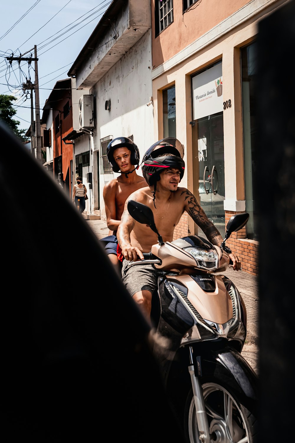 a couple of men riding on the back of a motorcycle