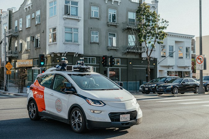 A self-driving test car with roof-mounted sensors stopped on a city street, similar to the autonomous vehicles now operating in Las Vegas