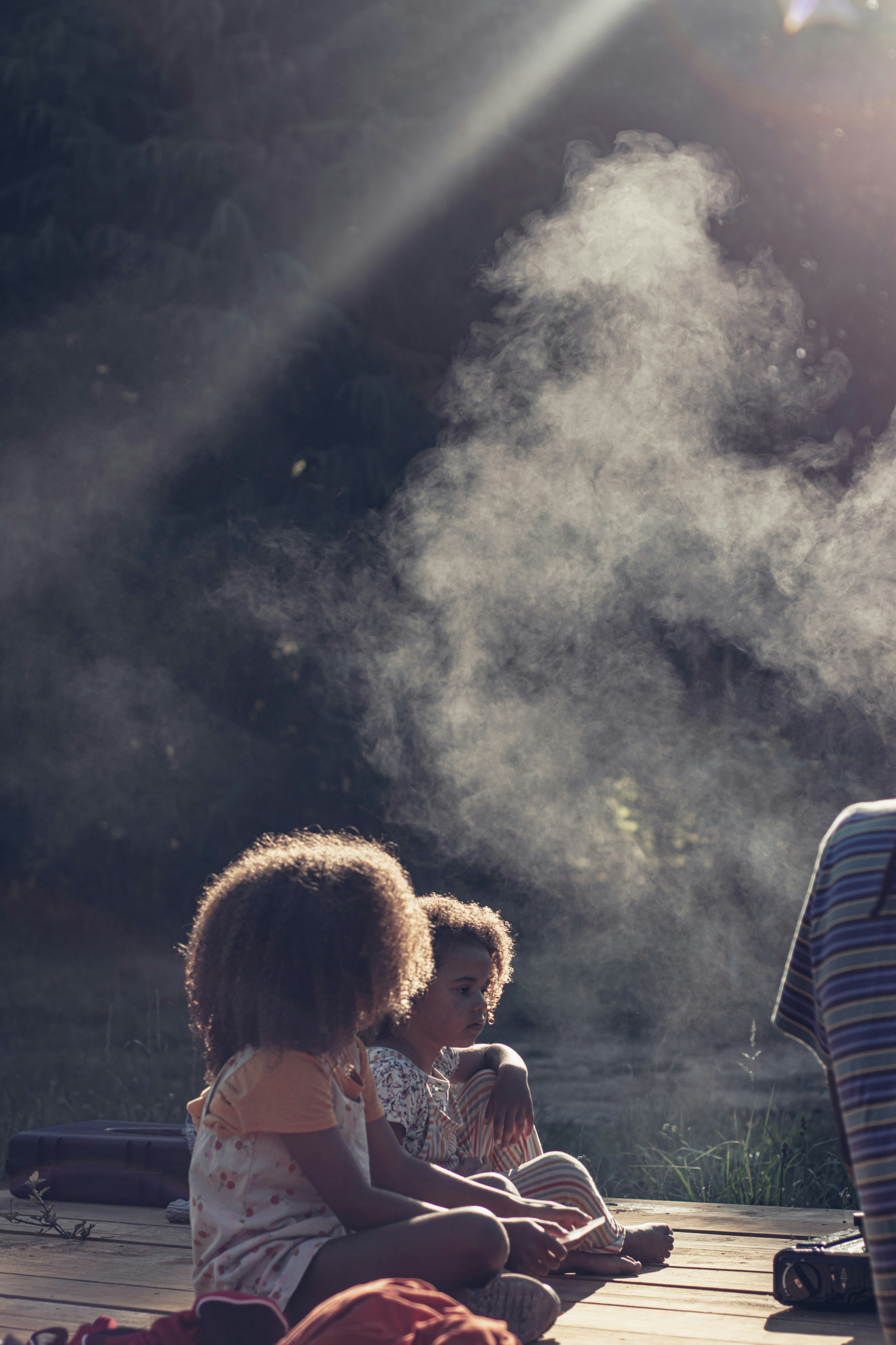 Family relaxing near an outdoor misting fan safety setup on a summer patio