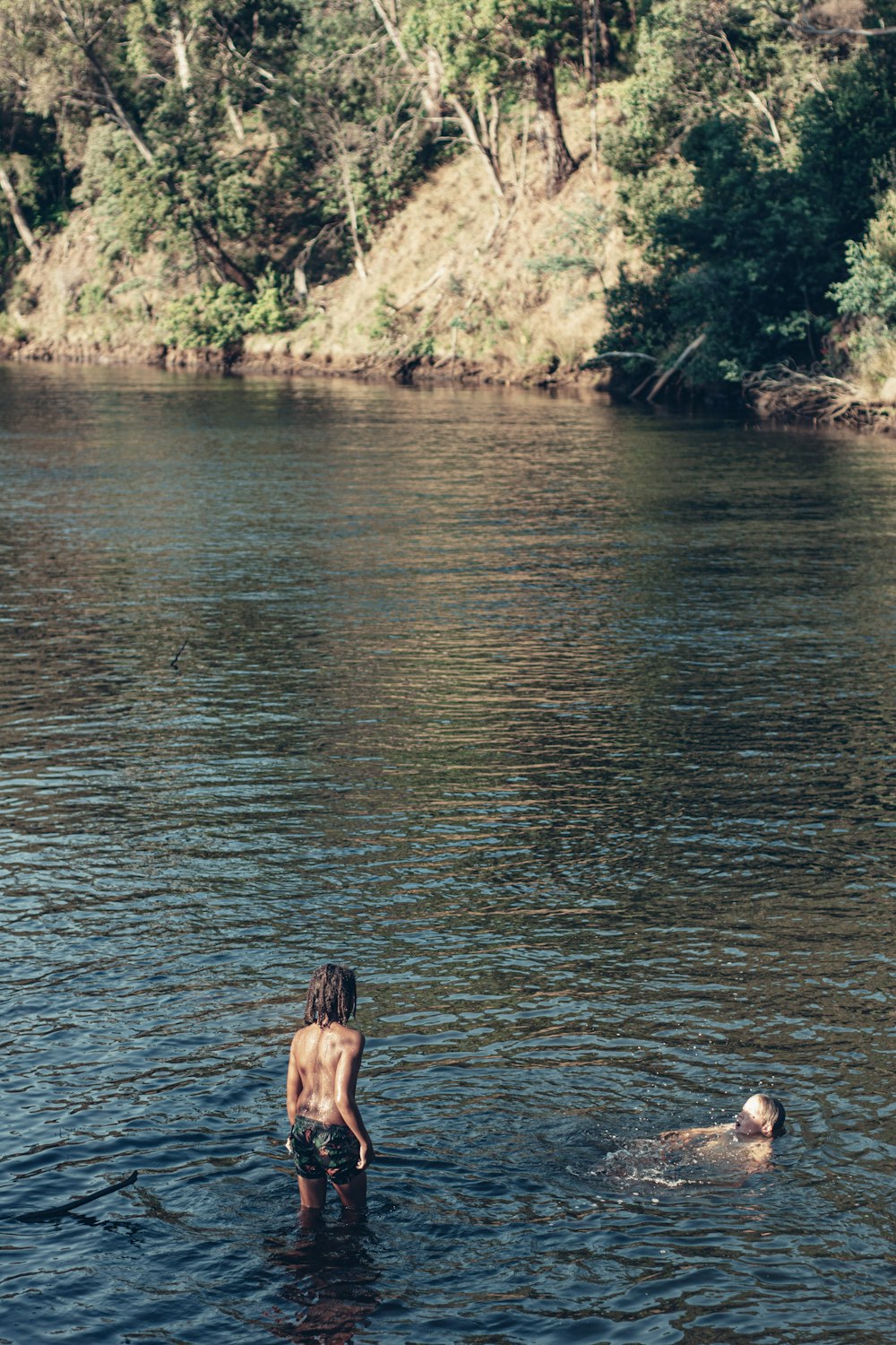 a person standing in a body of water with a frisbee