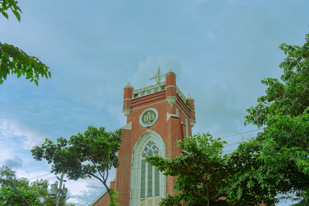 a tall red brick building with a clock on it's side