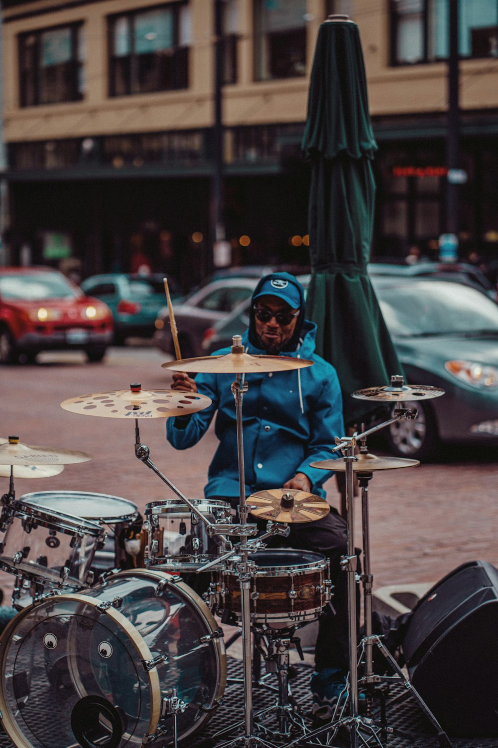 a man playing drums on a city street