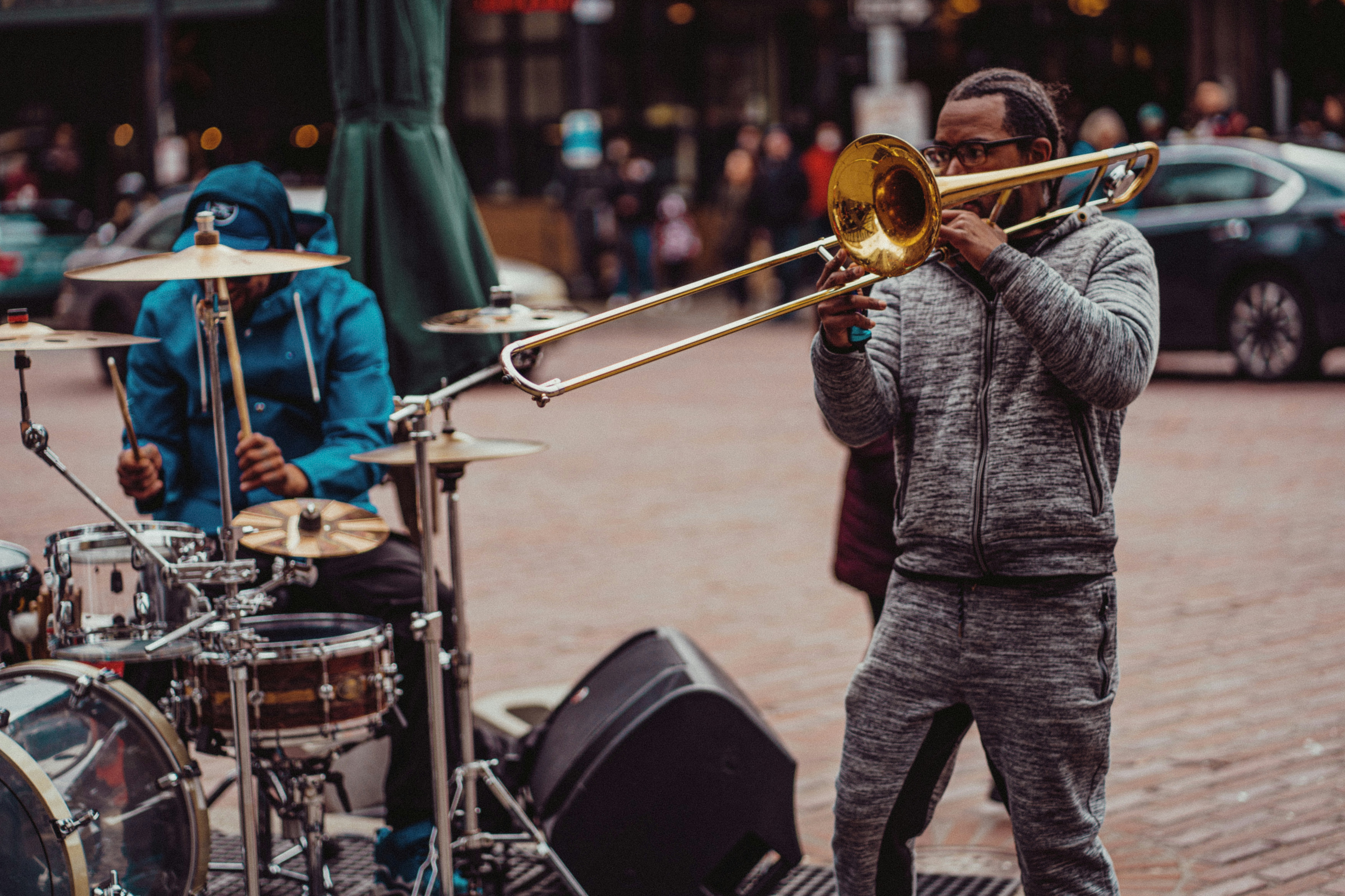 a man playing a trombone on the street
