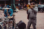 a man playing a trombone on the street