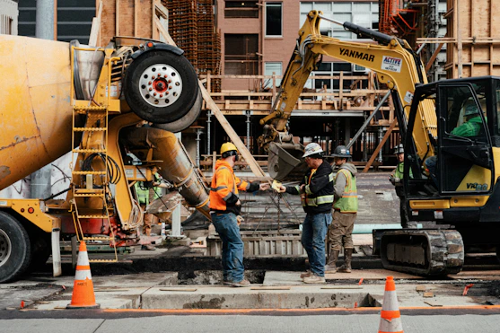 a couple of men standing next to a construction site
