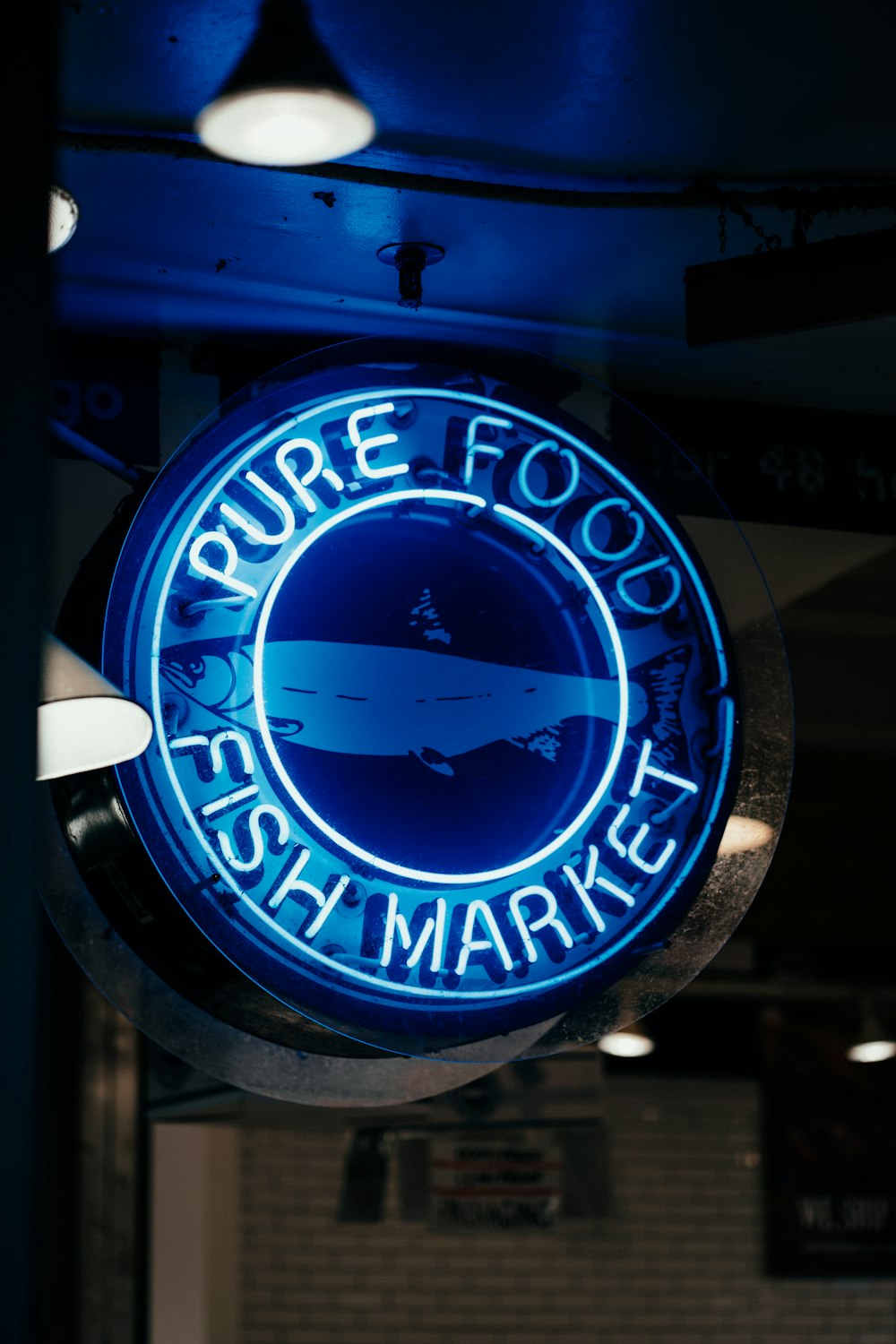 a neon sign hanging from the ceiling of a restaurant