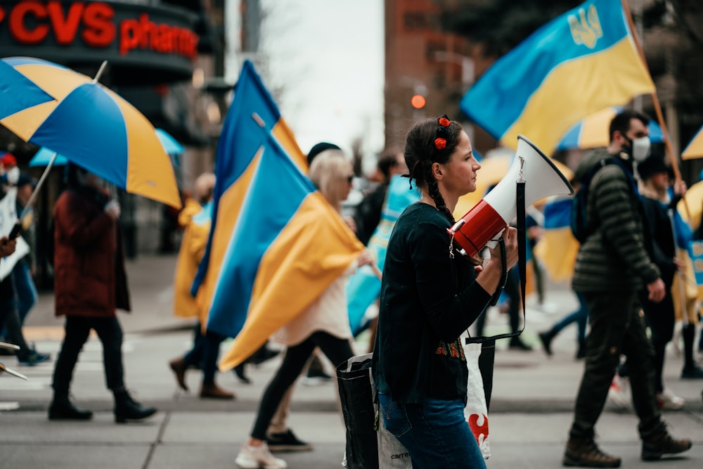 a woman holding a megaphone and some flags