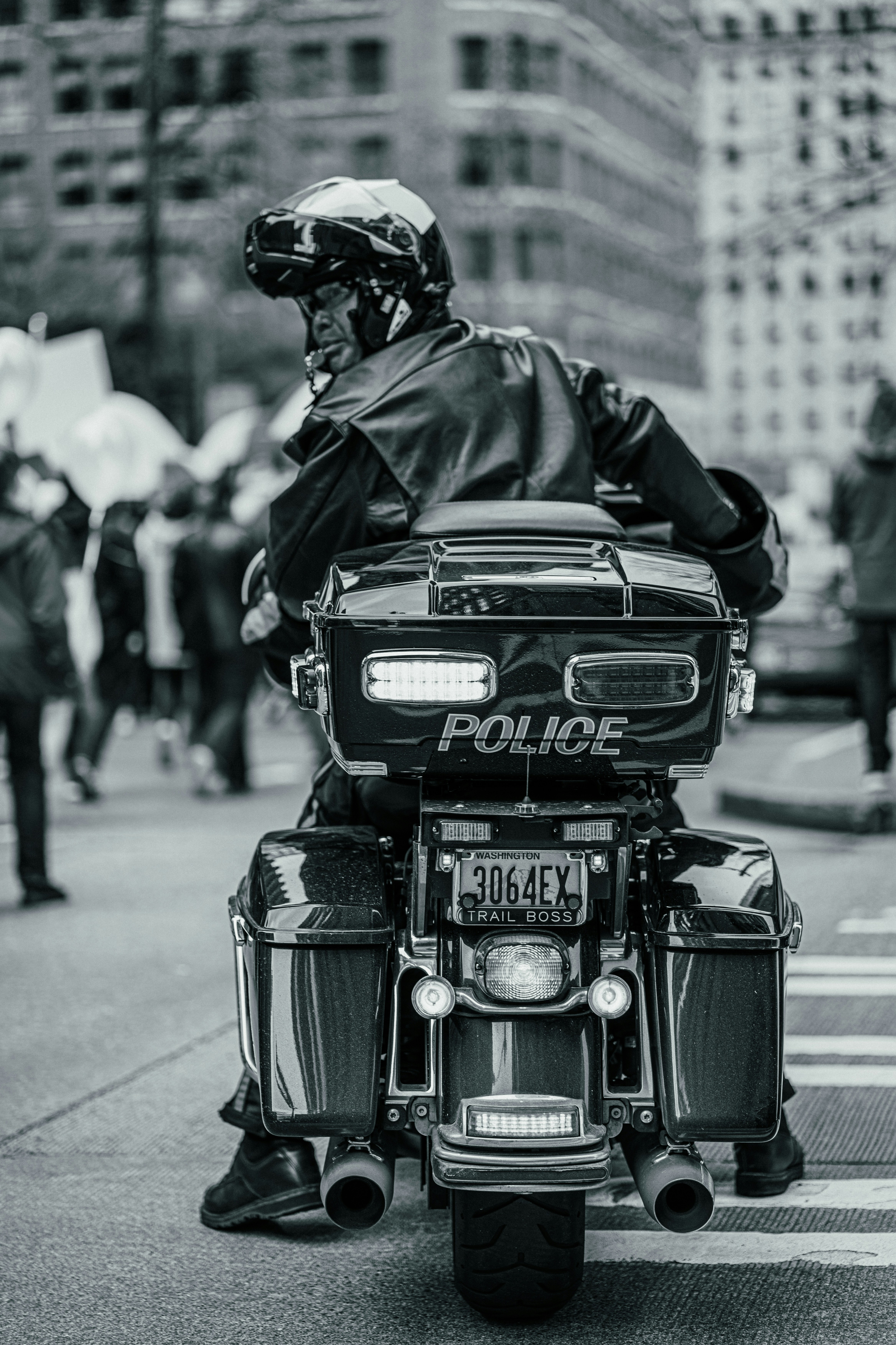 a police officer is riding a motorcycle down the street