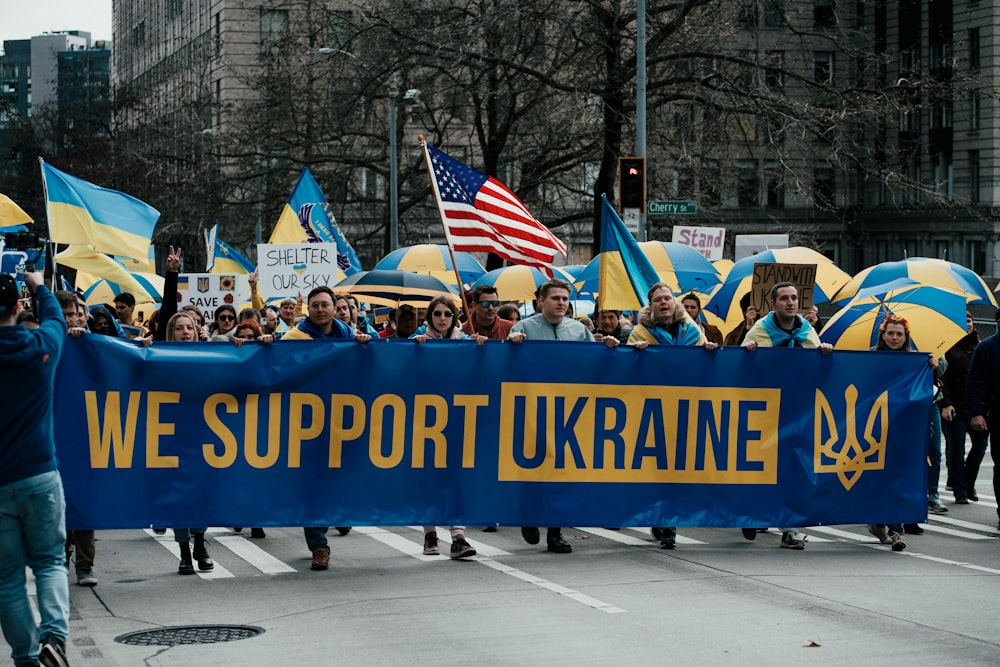 a large group of people marching down a street