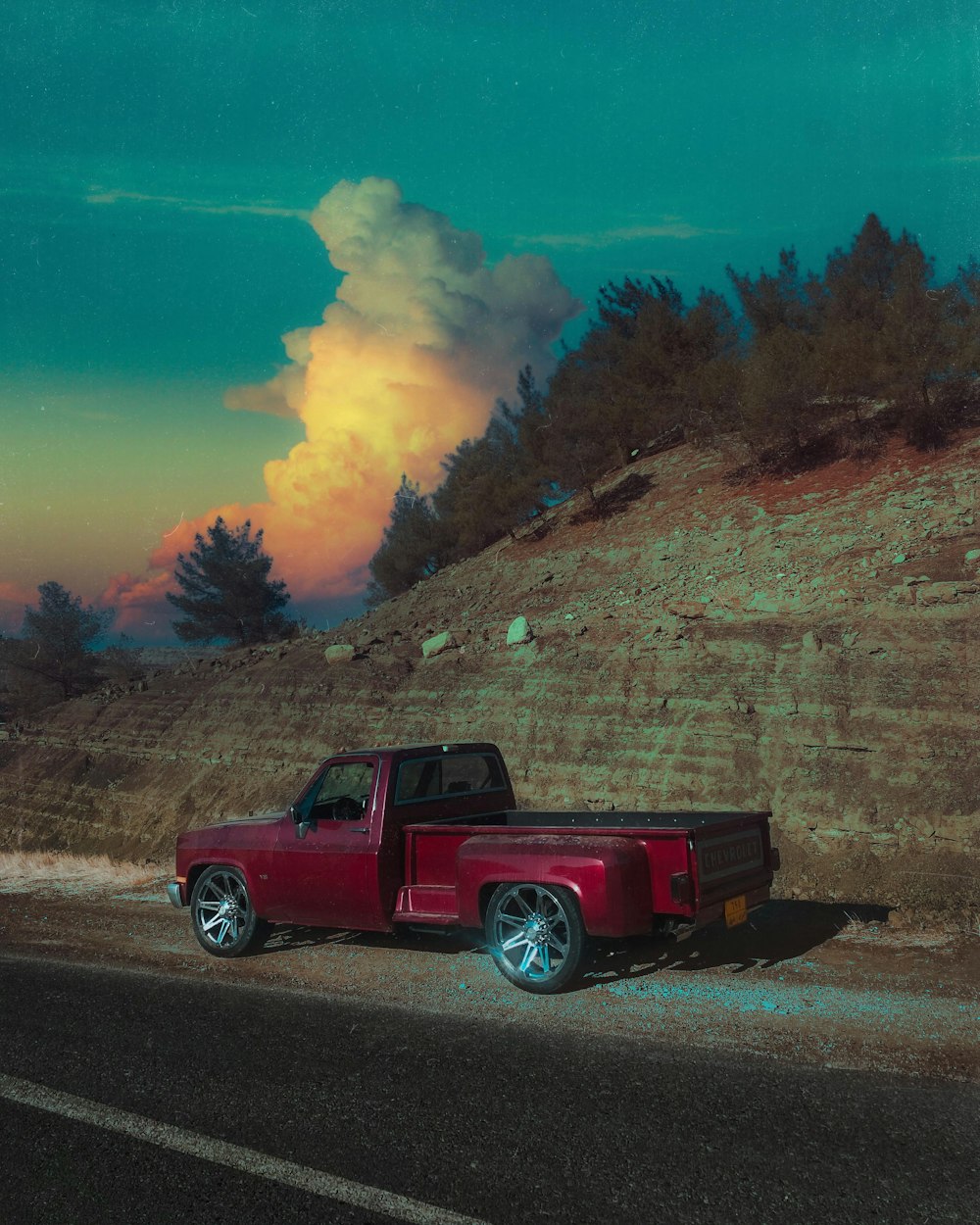 a red truck parked on the side of a road