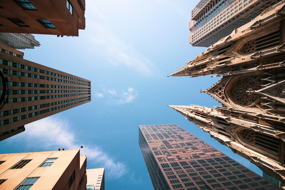 looking up at tall buildings in a city