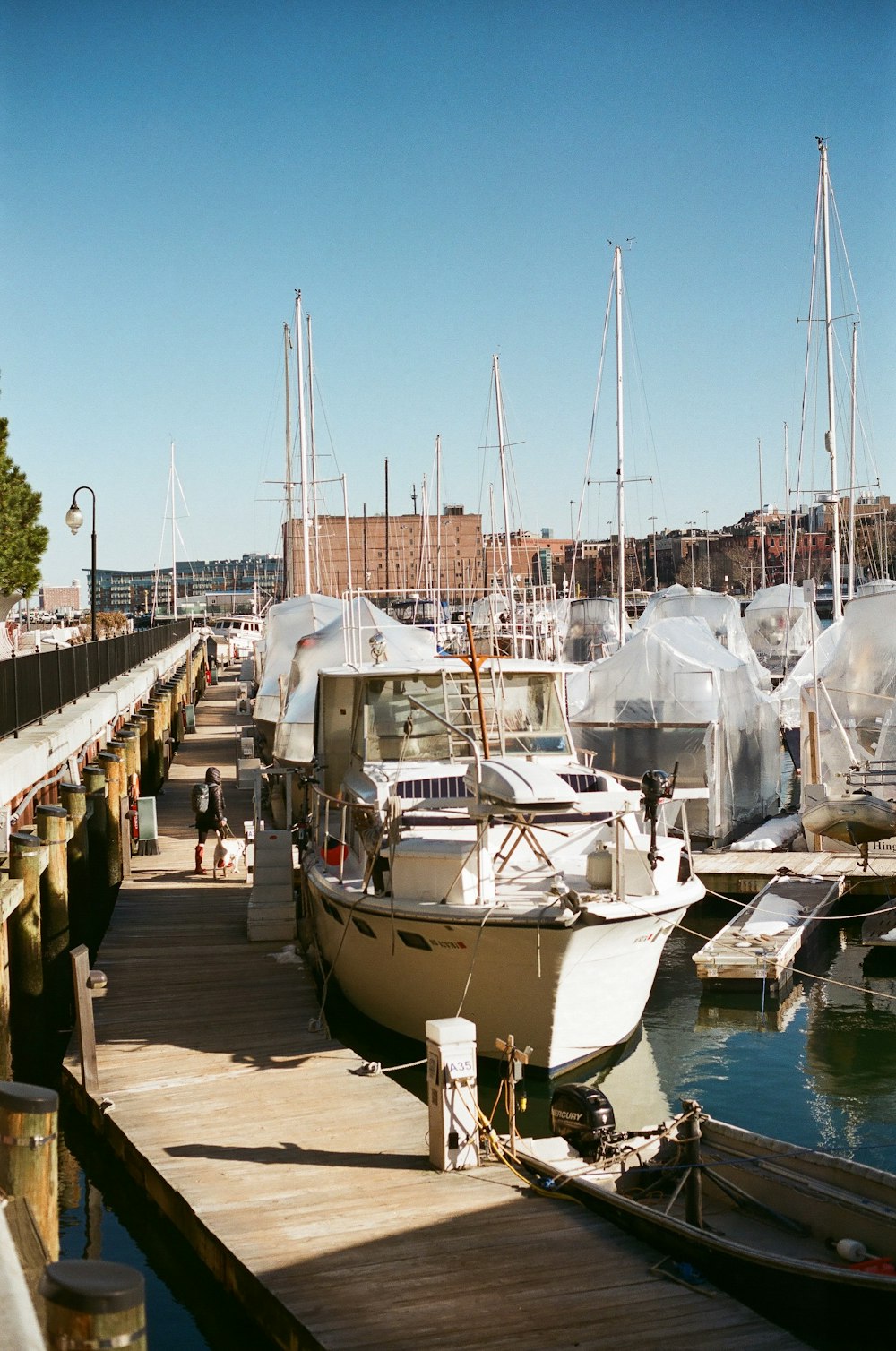 several boats are docked at a dock in a marina