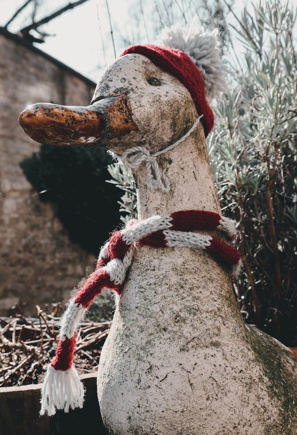 a statue of a duck wearing a hat and scarf