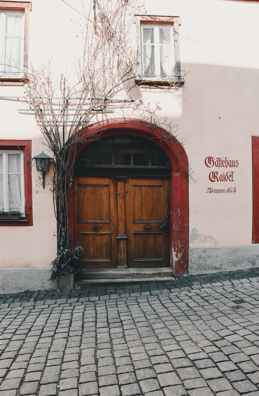 a red and white building with a wooden door