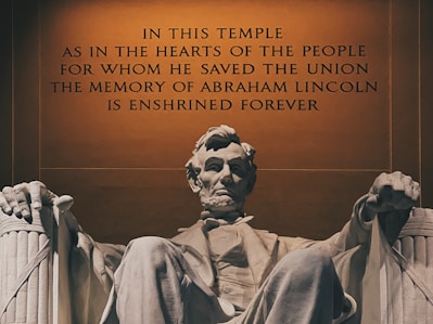 a statue of abraham lincoln in front of the lincoln memorial